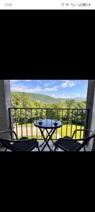 a table and chairs on a balcony with a view at Kechi Dom 6 in Tsaghkadzor +5 photos