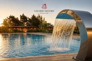 a water fountain in front of a swimming pool at Valerio Resort beach club in Margherita di Savoia +96 photos