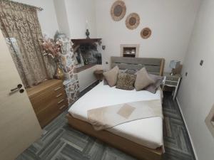 a bedroom with a bed and a window and a door at Vicky's House in Kos