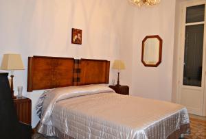 パレルモにあるPalazzo Ferruzzaのベッドルーム1室(ベッド1台、ランプ2つ、鏡付)