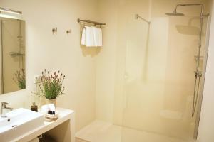 a bathroom with a shower and a sink at Hotel Casa Calella in Calella de Palafrugell +22 photos