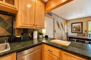 a kitchen with wooden cabinets and a counter top at Riverwood Lodge in Leavenworth +67 photos