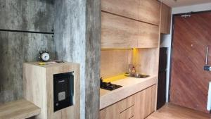 a kitchen with wooden cabinets and a sink at Ruby Apartment #47 in Kejayan