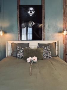 a bedroom with a bed with a painting on the wall at La Suite Archevêché by Collection Signature - Hypercentre Albi - Parking inclus in Albi