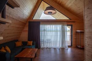 a living room with a couch and a table at Moretoni Lake Resort in Napareuli