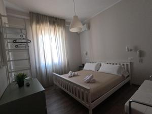 a bedroom with a bed with two towels on it at T Hotel- Adults Only, Pet Free Hotel in Rimini