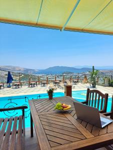 a table with a laptop and a bowl of fruit on it at Panoramic Konaklama Tesisi Bodrum in Bodrum City