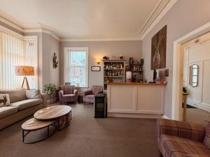 a living room with a couch and a table at Avenue Guest House in Blackpool