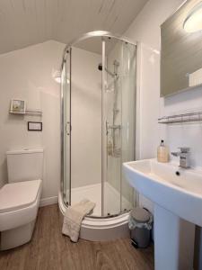 a bathroom with a shower and a toilet and a sink at Avenue Guest House in Blackpool +195 photos
