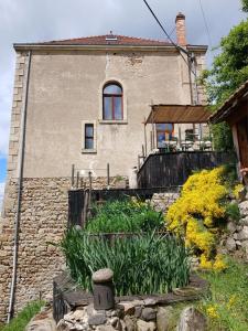 an old house with a garden in front of it at Gradine et Boucharde in Le Monastier sur Gazeille