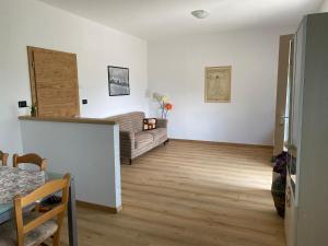 a living room with a couch and a table at Il Respiro del Brenta in San Lorenzo in Banale