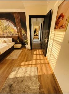 a living room with a bed and a hallway at Casa Do Cairo - Rehab City in Cairo
