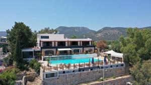 a large house with a swimming pool on a hill at Panoramic Konaklama Tesisi Bodrum in Bodrum City