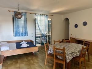 a bedroom with a table and a bed and a dining room at Villa Teti - Sicilia in Campofelice di Roccella
