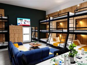 a living room with bunk beds and a couch at City Center Hostel Durres in Durrës