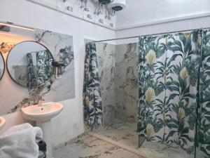 a bathroom with a shower and a sink at City Center Hostel Durres in Durrës +87 photos