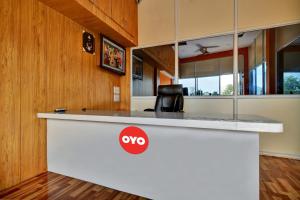 a kitchen with a white counter with avy sign on it at Hotel O My Choice in Indore
