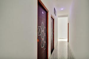 a hallway with a wall with graffiti on it at Hotel O My Choice in Indore