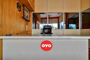 a white counter with aoops sign on top of it at Hotel O My Choice in Indore