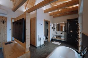 a bathroom with a white tub and a sink at Winzerhof - Deutsch Haseldorf in Deutsch Haseldorf