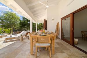 a dining room with a table and chairs on a patio at Casa del Viento Private Pool Villa near Kitesurf Beach and Sorobon in Kralendijk +32 photos