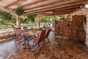 an outdoor dining room with a table and chairs at Emilia's Little Farmhouses in Agii Anargiri Milos +60 photos