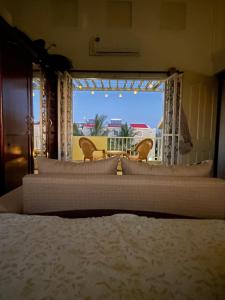 a bedroom with a bed and a view of a balcony at Triplex - Suite parentale in Grande Gaube