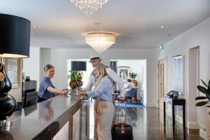 a man and woman standing at a kitchen counter at Belgrave Sands Hotel & Spa in Torquay +81 photos