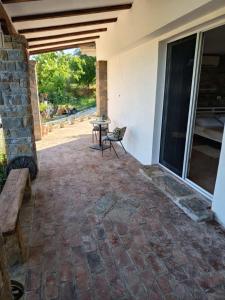 a patio with a table and a bench on a house at Room Monika in Izola