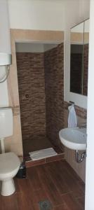 a bathroom with a shower and a toilet and a sink at Room Monika in Izola