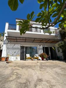 a white house with two chairs and a balcony at Son Roca Ribes Guest House in Sant Pere de Ribes