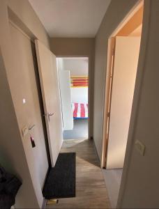 a hallway with a door open to a bedroom at L Escale du Lioran in Le Lioran
