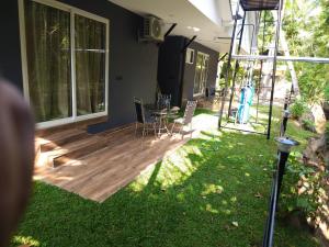 a patio with a table and chairs in a yard at Creek Cottage in Kollam +13 photos
