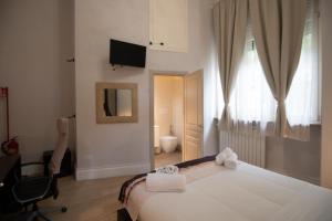 a bedroom with a bed and a chair and a window at Superior Room - Smart Working - 100m from center in Salerno +5 photos