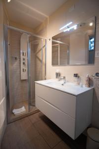 a bathroom with a white sink and a shower at Superior Room - Smart Working - 100m from center in Salerno