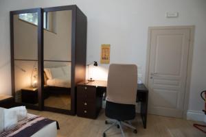 a bedroom with a desk and a bed and a mirror at Superior Room - Smart Working - 100m from center in Salerno