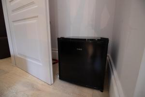 a black trash can sitting next to a door at Superior Room - Smart Working - 100m from center in Salerno