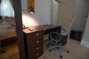 a bedroom with a desk and a chair next to a bed at Superior Room - Smart Working - 100m from center in Salerno