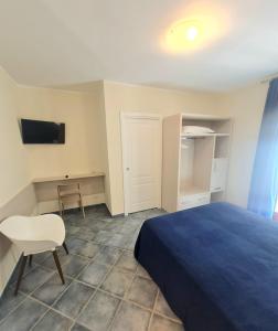 a bedroom with a bed and a chair and a desk at La Piazzetta Affittacamere B&B in Numana