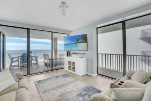 a living room with a view of the ocean at Corner on Romar 706 in Orange Beach