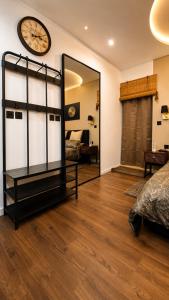 a bedroom with a mirror and a clock on the wall at D'Arte Suite in Tal-Liedna