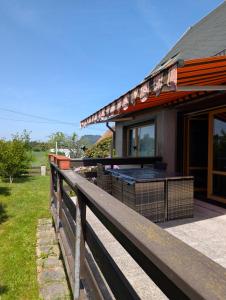 a house with a wooden fence in front of it at Your home in Gohrisch in Kurort Gohrisch