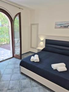 a bedroom with a bed with two white towels on it at La Piazzetta Affittacamere B&B in Numana