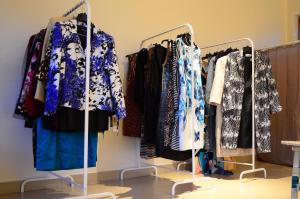 a bunch of clothes on racks in a store at Koi Koi, Fort Portal in Fort Portal