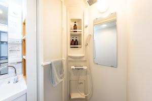 a bathroom with a shower with a sink and a mirror at 第2舞鶴ハイツ in Fukuoka +282 photos