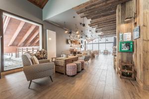 a dining room with chairs and a table in a room at Les Roches du Mont Blanc - Résidence & Spa in Combloux
