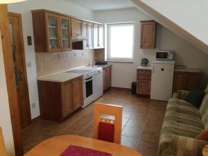 a kitchen with a couch and a table in a room at Apartmán u Kovářů in Kašperské Hory