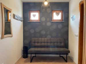a bench in a room with hearts on the wall at Ferienhaus Engel in Fertőhomok