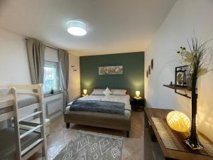 a bedroom with a bed and a bunk bed and a table at Ferienhaus Engel in Fertőhomok
