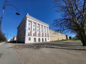 a large white building on the side of a street at Keskallee Charm in Kohtla-Järve